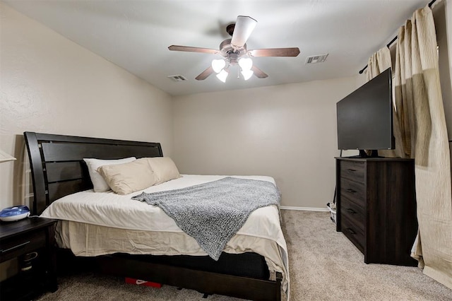 carpeted bedroom with baseboards, visible vents, and a ceiling fan