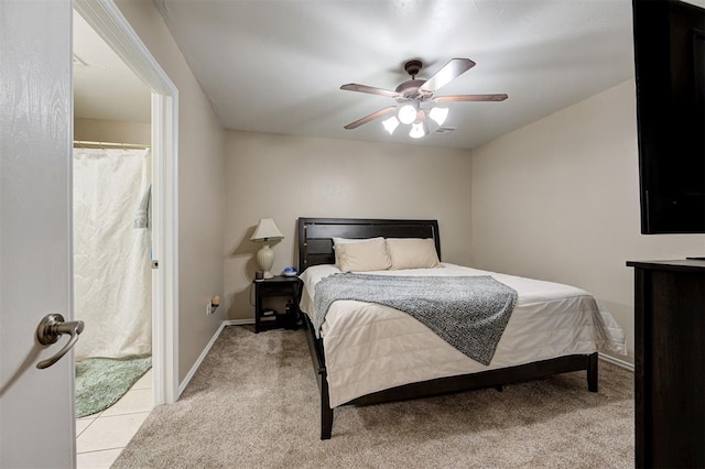 bedroom featuring light colored carpet, ceiling fan, and baseboards