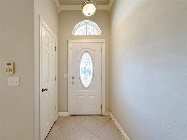 doorway to outside featuring light tile patterned floors, baseboards, and ornamental molding