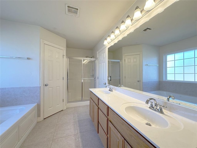 bathroom featuring visible vents, a sink, and a bath