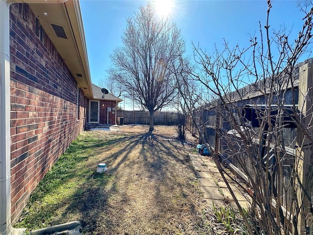 view of yard with a fenced backyard