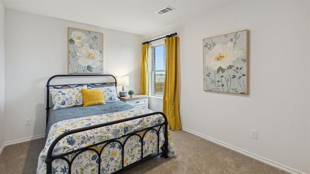 carpeted bedroom with visible vents and baseboards