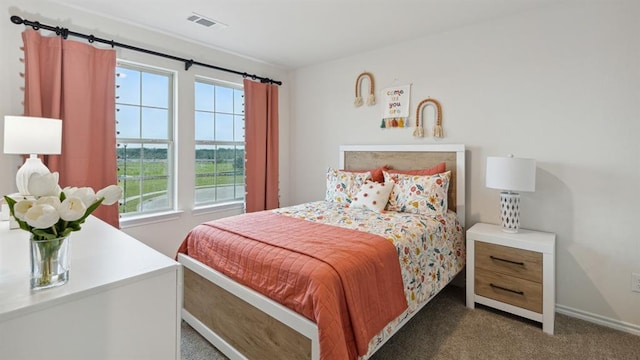 carpeted bedroom with visible vents and baseboards