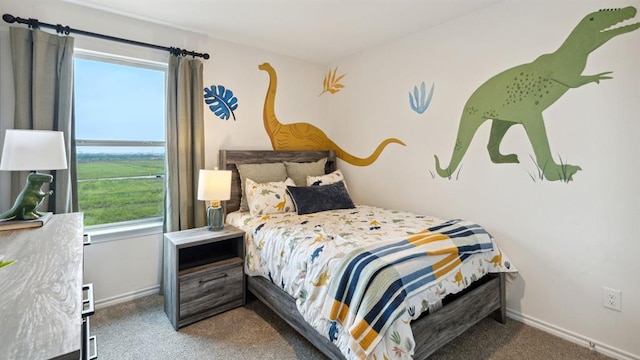 bedroom featuring carpet and baseboards