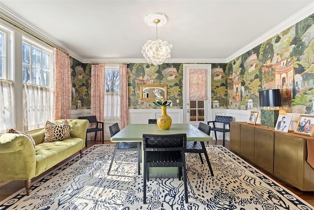 interior space featuring ornamental molding, wainscoting, and wallpapered walls