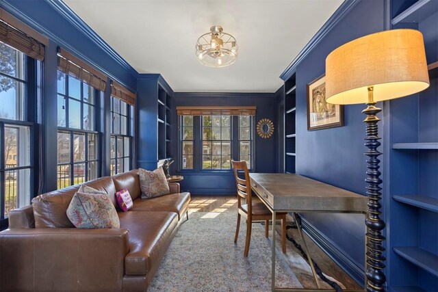 office space with built in shelves, a notable chandelier, and crown molding