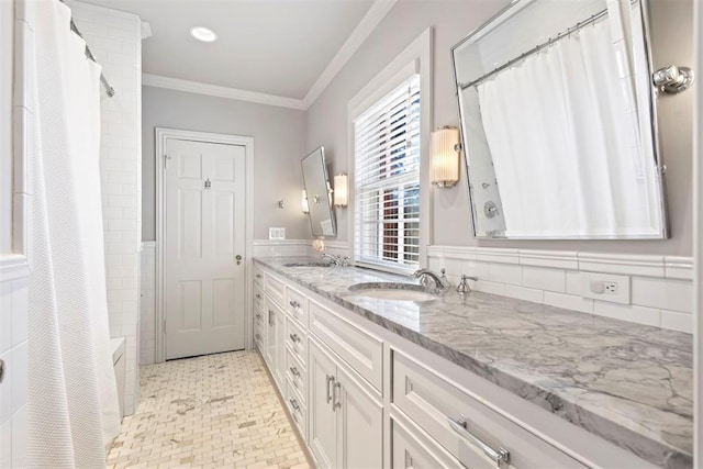 bathroom with double vanity, ornamental molding, shower / bath combo, and a sink