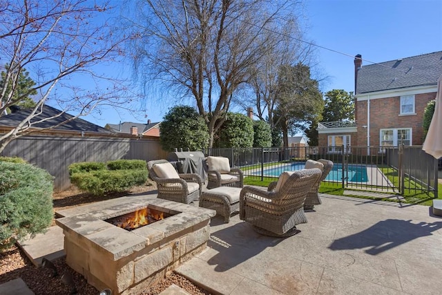 view of patio / terrace with an outdoor fire pit, fence, and a fenced in pool