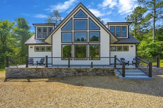 rear view of property featuring a patio area and metal roof