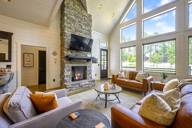 living room with wood ceiling, a fireplace, and wooden walls