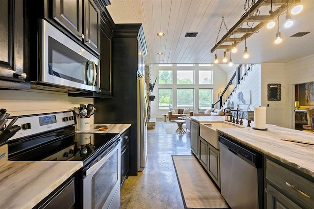 kitchen featuring visible vents, appliances with stainless steel finishes, wood ceiling, open floor plan, and a sink