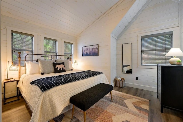 bedroom with wooden walls, baseboards, lofted ceiling, wooden ceiling, and wood finished floors