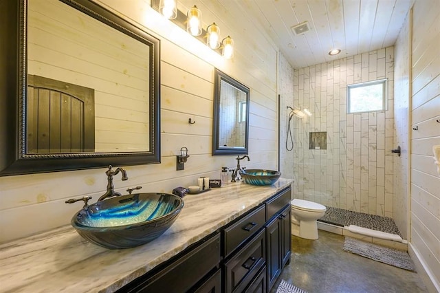 bathroom featuring double vanity, a sink, toilet, and walk in shower