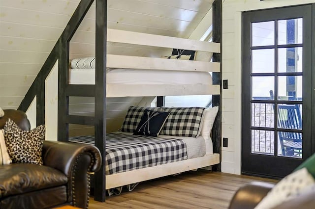 bedroom featuring vaulted ceiling and wood finished floors