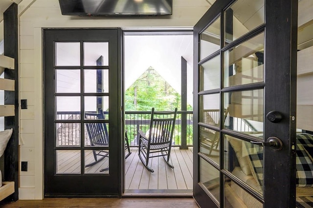 doorway with wood finished floors and french doors