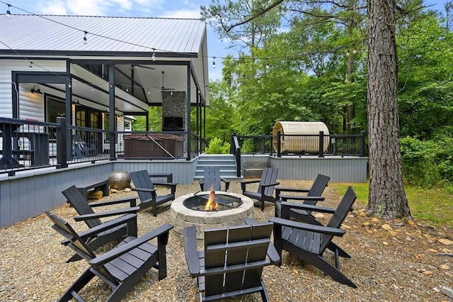 view of patio / terrace with an outdoor fire pit and a deck