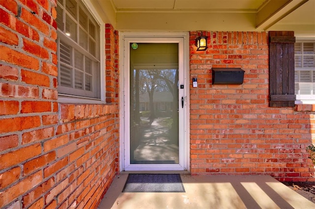 property entrance with brick siding