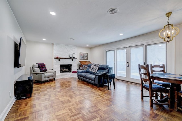 living area with a fireplace, recessed lighting, visible vents, an inviting chandelier, and baseboards