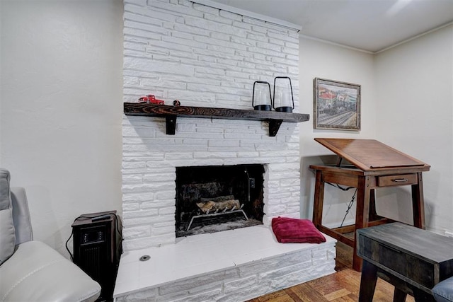 interior details with a fireplace, crown molding, and wood finished floors