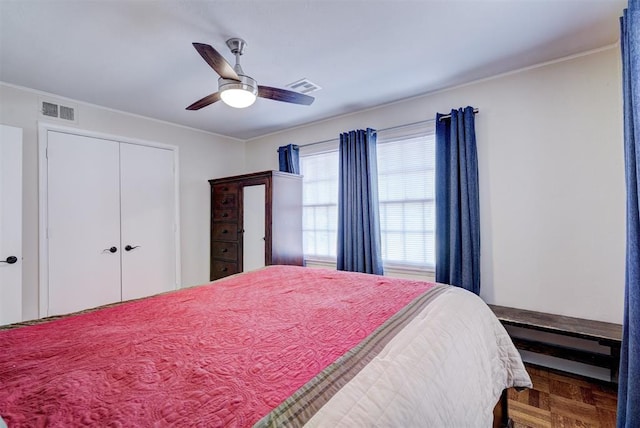 bedroom with ceiling fan, a closet, visible vents, and crown molding