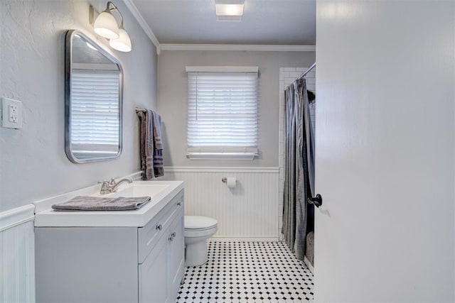 full bath with a wainscoted wall, curtained shower, toilet, ornamental molding, and vanity