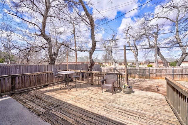 wooden deck featuring a fenced backyard