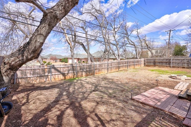 view of yard featuring a patio area, an outdoor fire pit, and a fenced backyard