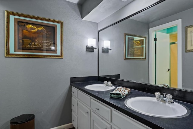 full bathroom with double vanity and a sink