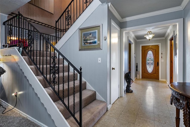 entryway featuring tile patterned floors, stairway, baseboards, and ornamental molding