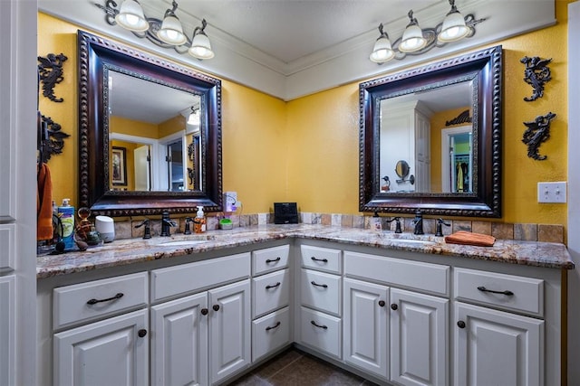 bathroom with double vanity, tile patterned flooring, crown molding, and a sink