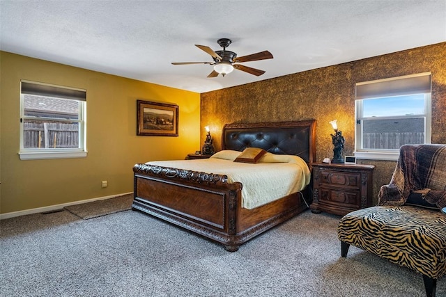 carpeted bedroom with baseboards, a textured ceiling, and a ceiling fan