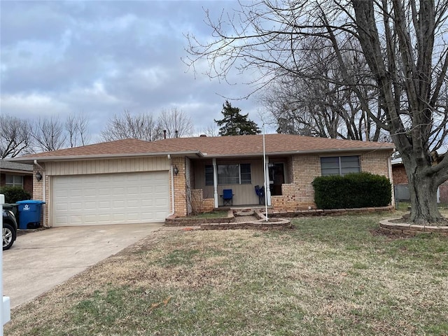 single story home with a garage, a front yard, concrete driveway, and brick siding