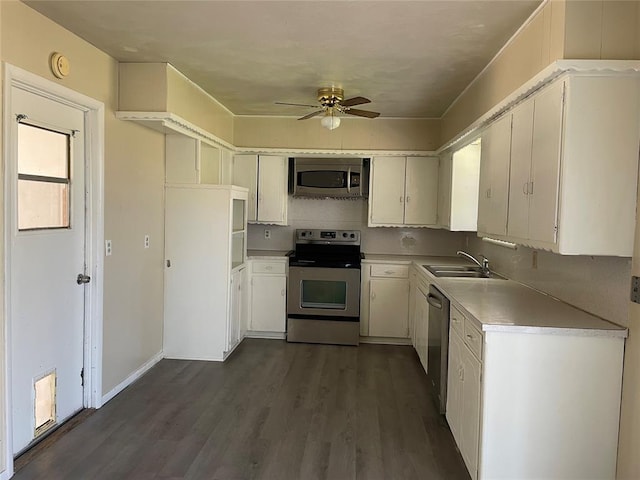 112 N King Ave, Midwest City, OK 73130 - kitchen featuring dark wood finished floors, light countertops, appliances with stainless steel finishes, a ceiling fan, and a sink