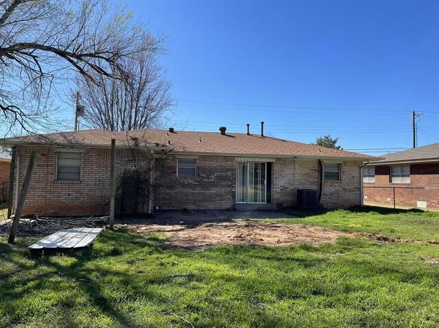 112 N King Ave, Midwest City, OK 73130 - rear view of property with a yard, brick siding, and central AC