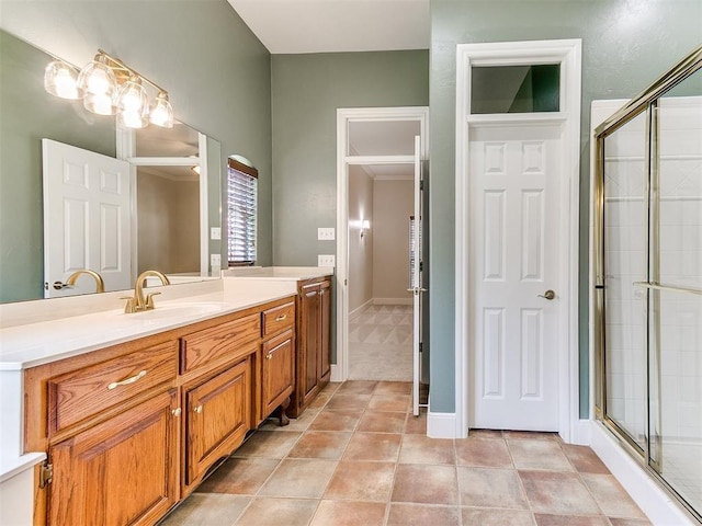 bathroom featuring baseboards, a shower stall, vanity, and tile patterned floors