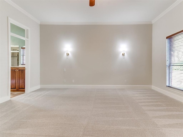 unfurnished room with baseboards, ornamental molding, and light colored carpet