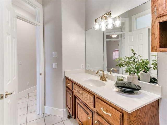 bathroom featuring tile patterned flooring, vanity, and baseboards