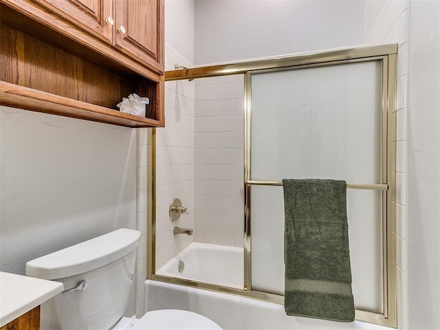 full bathroom with vanity, toilet, and bath / shower combo with glass door