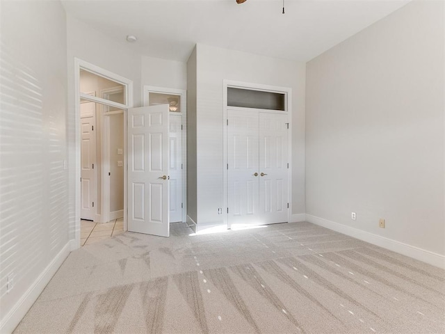 unfurnished bedroom featuring a closet, carpet, and baseboards