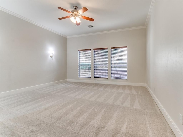 unfurnished room featuring ceiling fan, light carpet, visible vents, baseboards, and crown molding