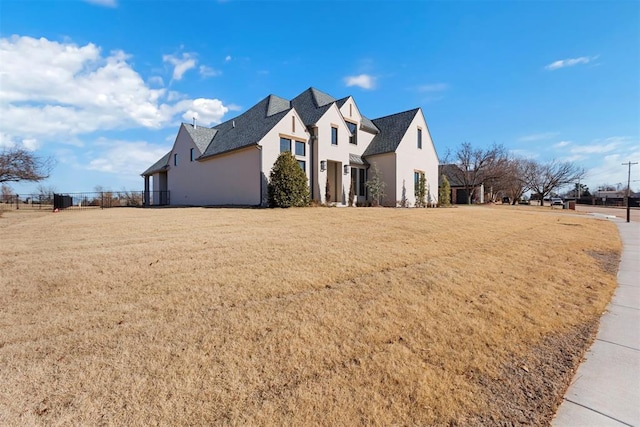 view of front of house featuring a front lawn and stucco siding