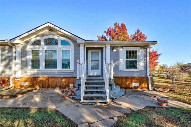 view of front facade with crawl space and fence