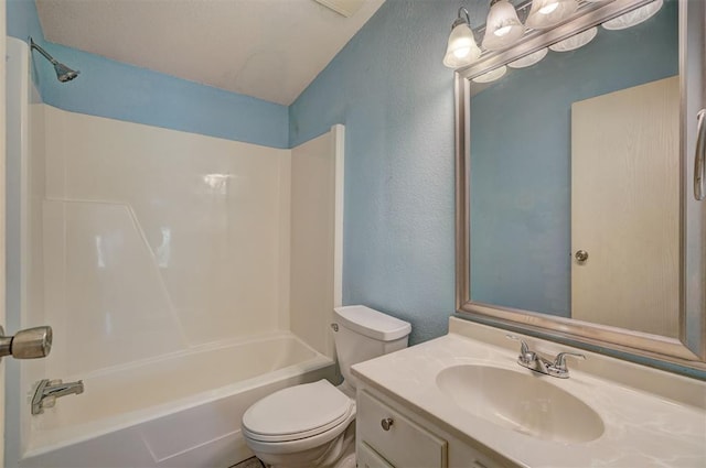 bathroom with toilet, a textured wall, washtub / shower combination, and vanity