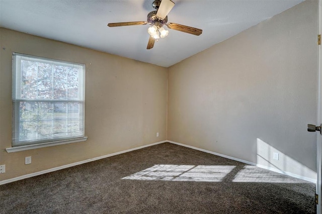 carpeted empty room with ceiling fan and baseboards