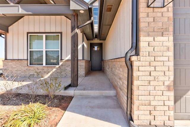 property entrance featuring brick siding