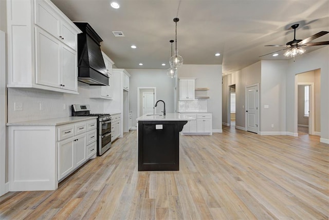 kitchen with open shelves, range with two ovens, custom exhaust hood, light countertops, and tasteful backsplash