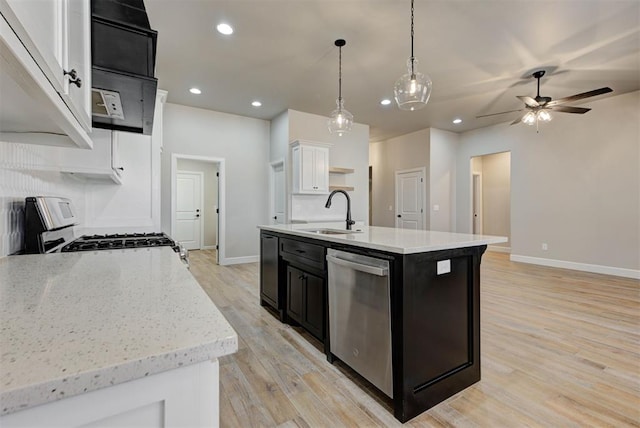 kitchen featuring open shelves, dark cabinets, stainless steel dishwasher, gas stove, and a sink