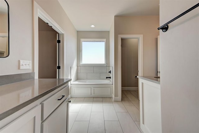 full bath with a garden tub and vanity