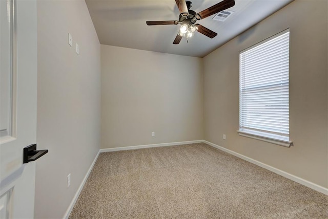 unfurnished room featuring visible vents, baseboards, carpet, and ceiling fan