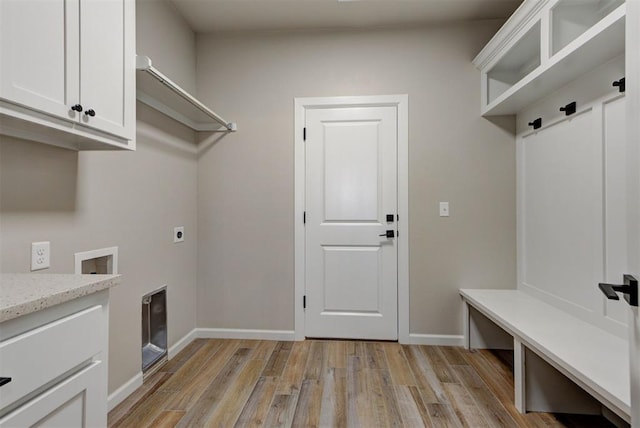 interior space with baseboards and light wood finished floors